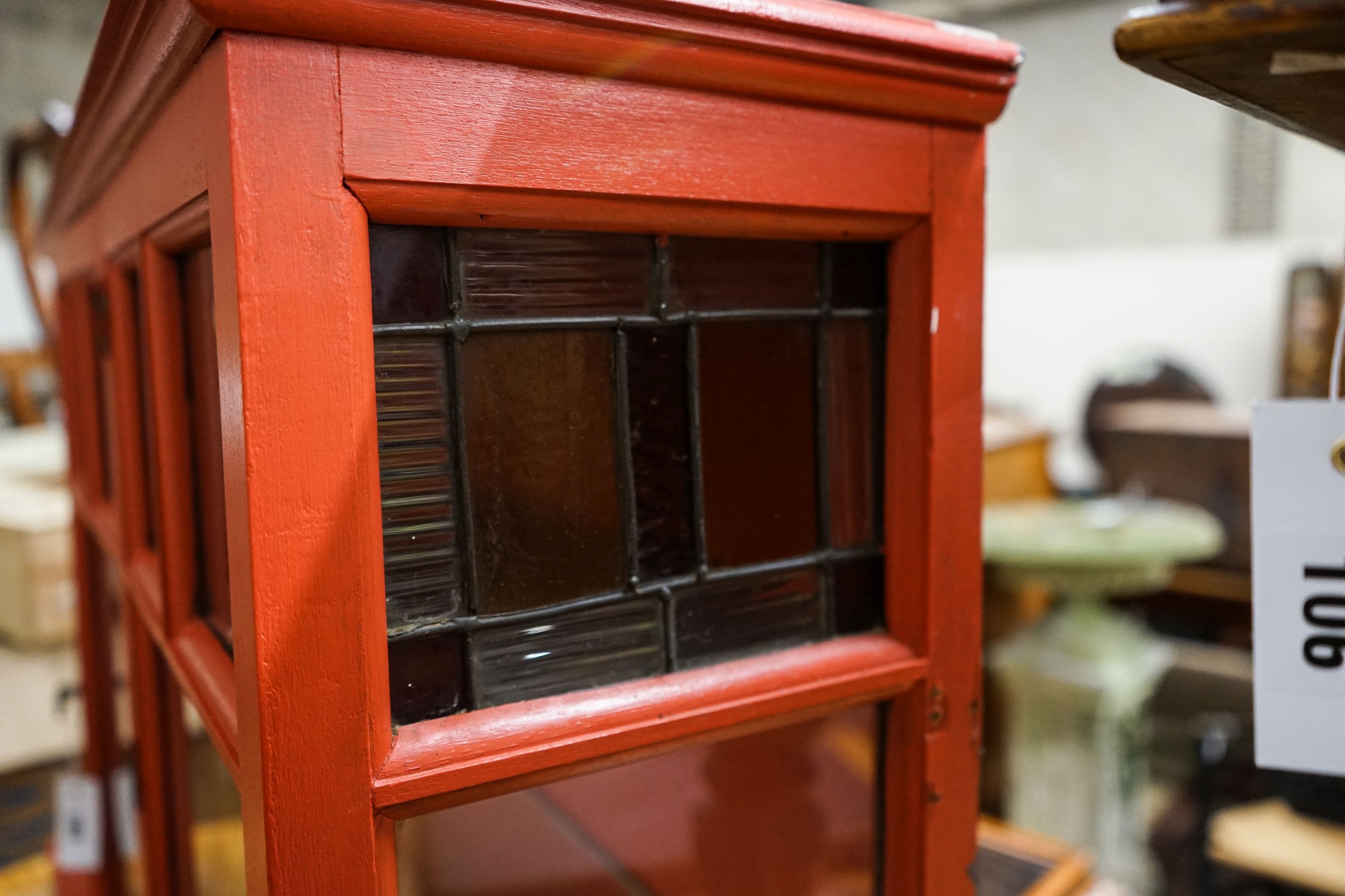 A painted glazed two door wall cabinet with mirrored interior, width 109cm, depth 26cm, height 68cm